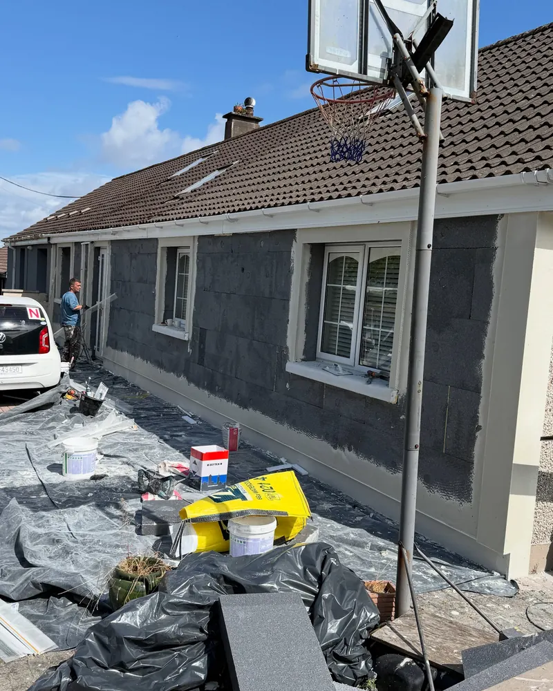 Insulation boards fixed across the front of the bungalow